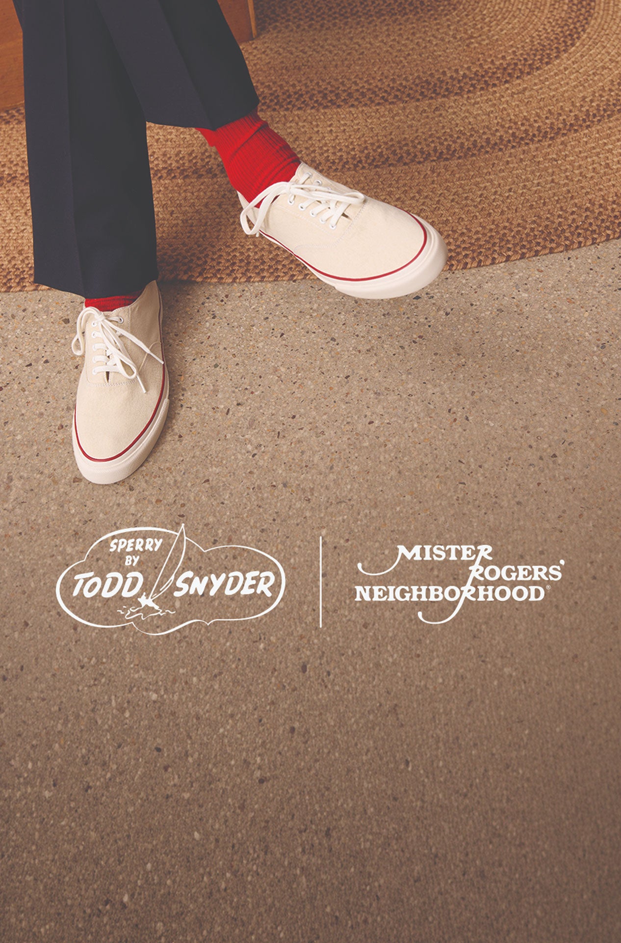 Person in navy trousers and red socks wearing white Sperry x Todd Snyder CVO canvas sneakers with red accent stitching, seated beside a braided rug on a terrazzo floor, with Sperry by Todd Snyder and Mister Rogers' Neighborhood logos overlaid.