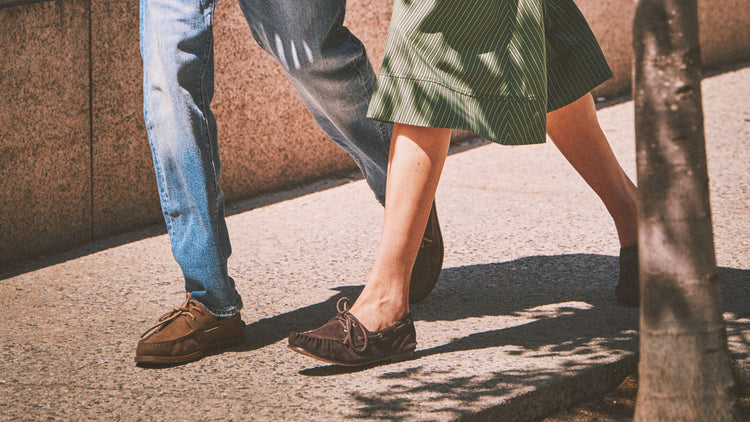 Man in a white eyelet top and taupe trousers seated on a stool, wearing cream woven leather Sperry boat shoes, alongside a close-up showing the perforated texture and rope lacing detail.