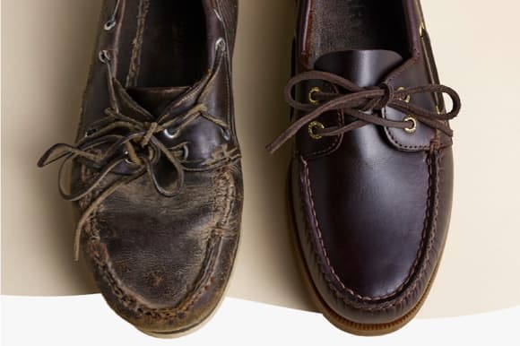 Side-by-side top-down view of two Sperry leather boat shoes — one heavily worn with creased and weathered leather, the other in new condition with smooth dark burgundy leather, highlighting the contrast between aged and new.