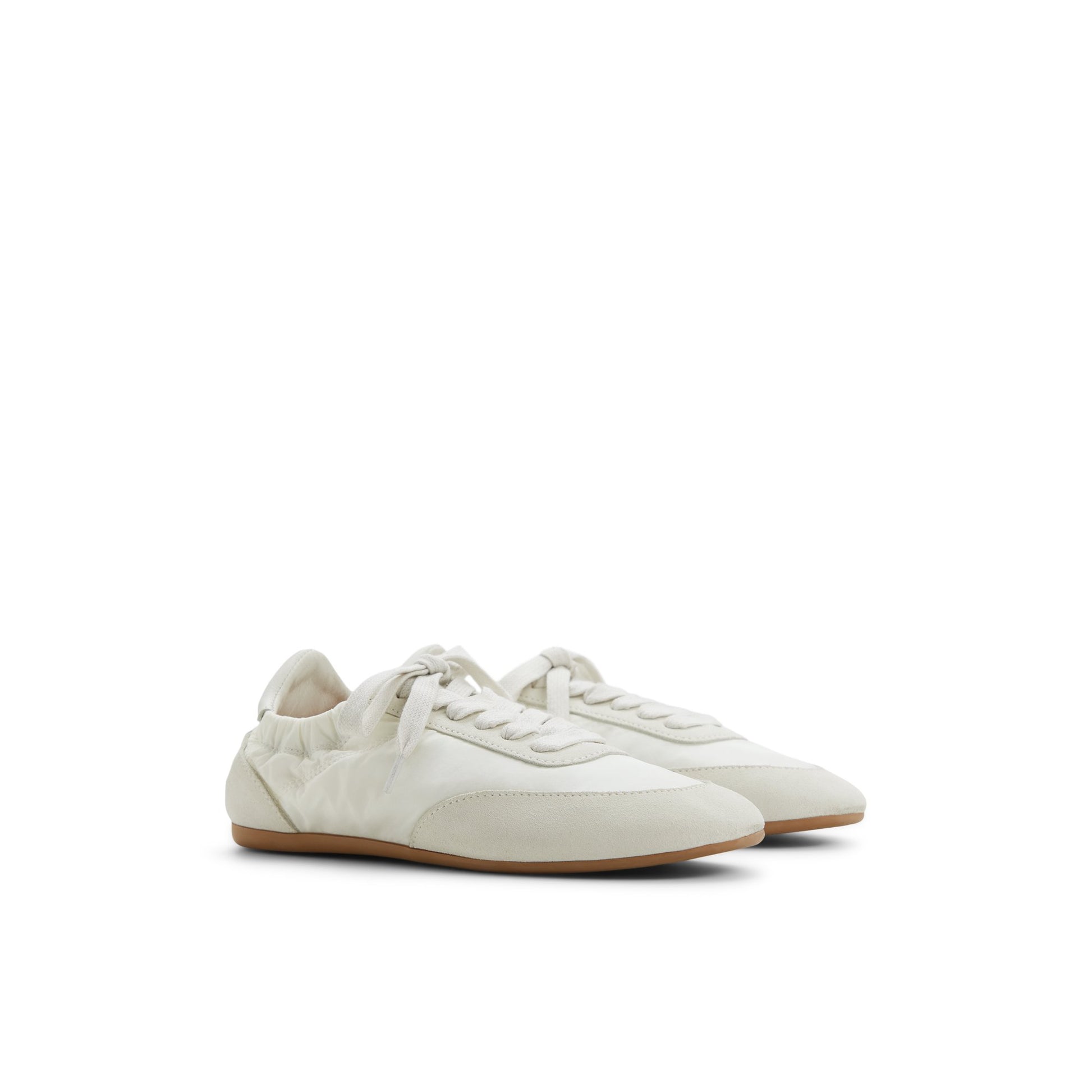 Side view of Ivory Sperry x Aritzia Slim Jogger Low Top Sneakers